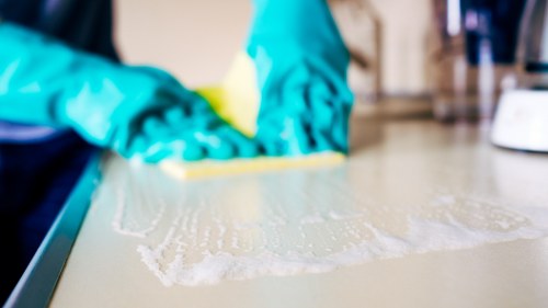 Deep cleaning kitchen surfaces and cupboards before moving in